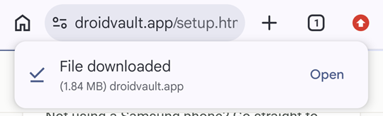 Chrome's File downloaded bar under the address bar, showing 1.84 MB from droidvault.app, with an Open link on the right.